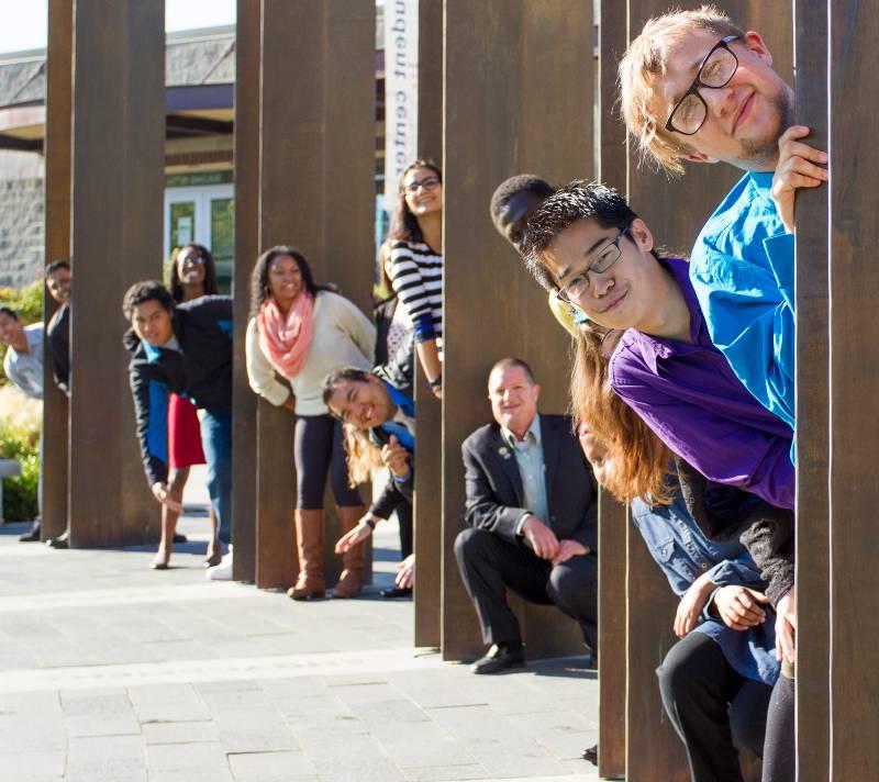 TCC students standing by the pillars in the Campus commons